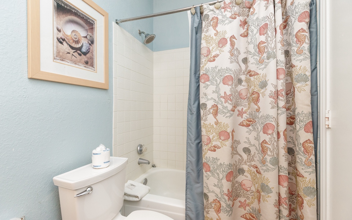 Refresh in your private bathroom with soothing coastal colors and a charming seashell-themed shower curtain that brings seaside tranquility to your daily routine.