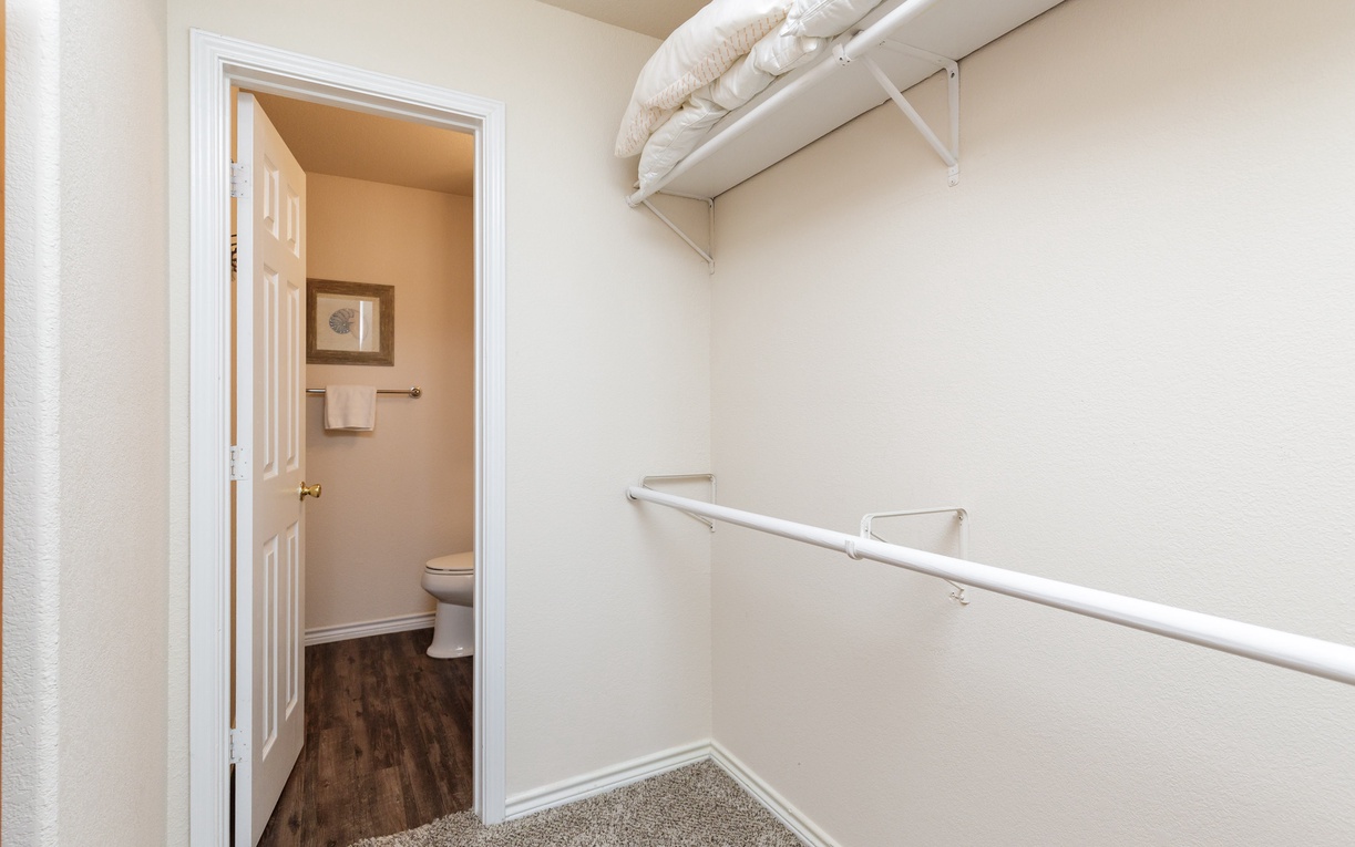 Your spacious walk-in closet features convenient shelving and hangs, with a private bathroom just steps away for your comfort.