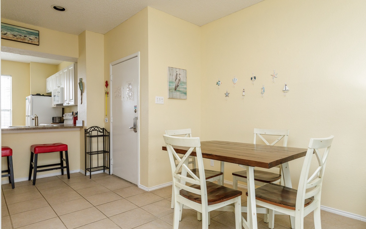 Gather around your charming dining table for morning coffee or evening meals in this bright, coastal-themed space.