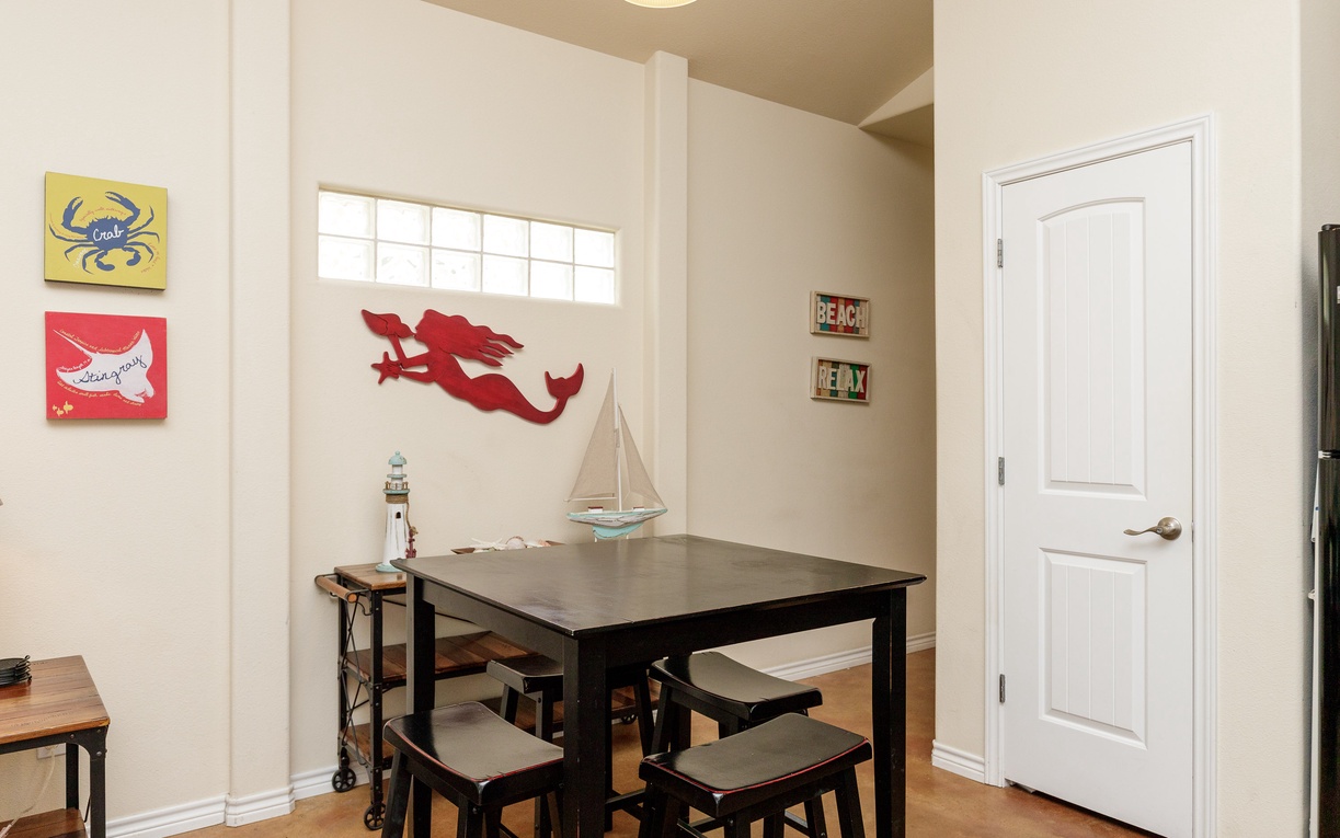 Gather around your charming dining table, surrounded by playful beach art and nautical touches that make every meal feel like a coastal escape.