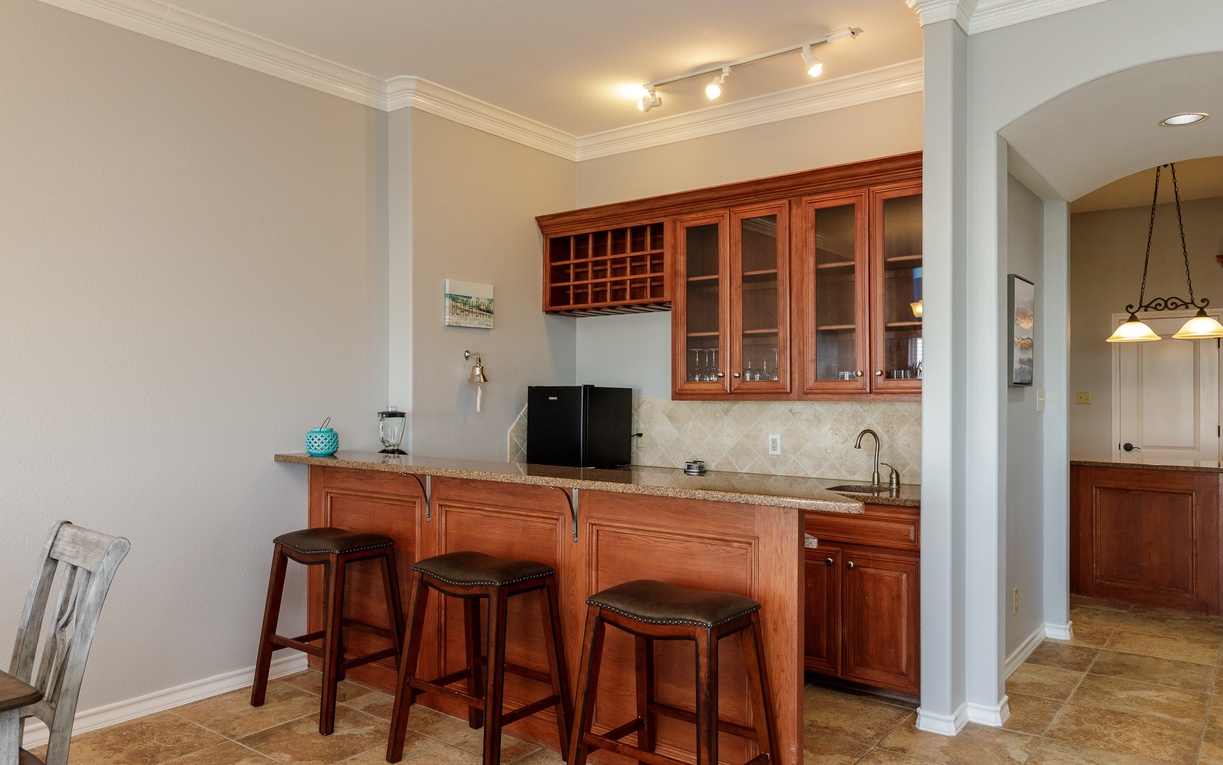 Your elegant kitchen awaits with rich cherry cabinets, granite counters, and a convenient breakfast bar perfect for morning coffee or evening wine.