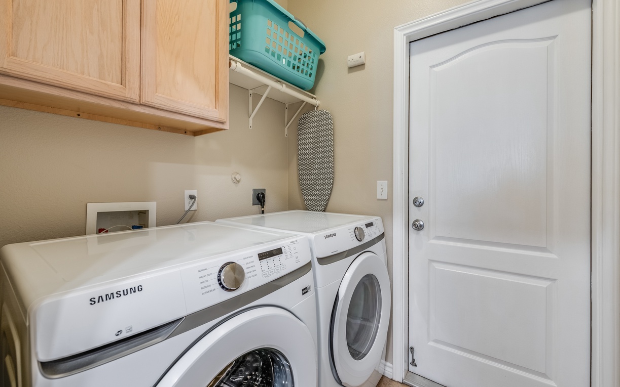 Your dedicated laundry room features Samsung washer and dryer, thoughtful storage solutions, and everything needed for effortless care of your belongings.