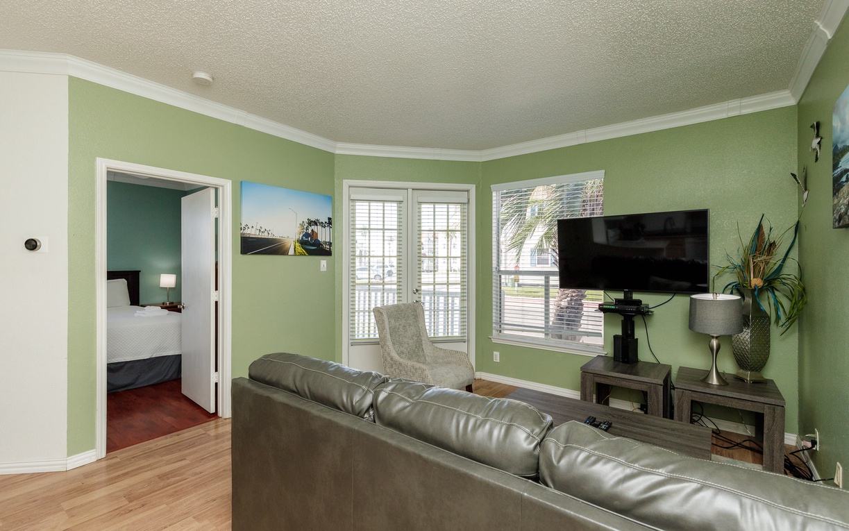 Sink into the plush leather sofa and enjoy your favorite shows on the flat-screen TV in this bright, welcoming living space.