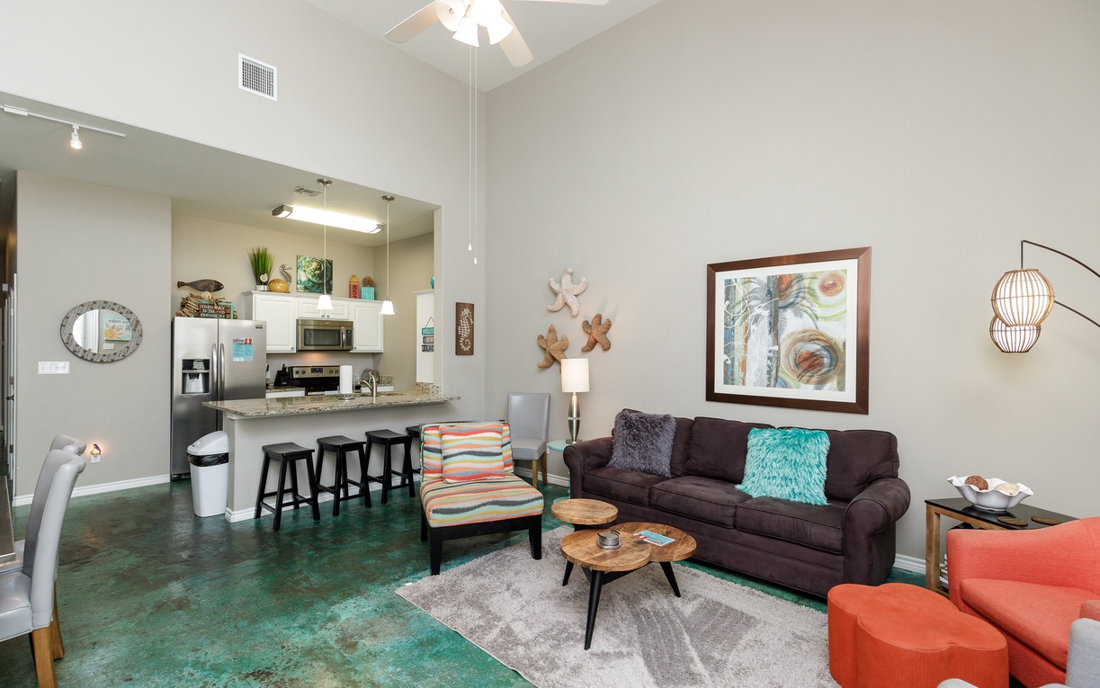 Relax in your bright, modern living space with stylish furnishings, comfortable seating, and a fully equipped kitchen just steps away.