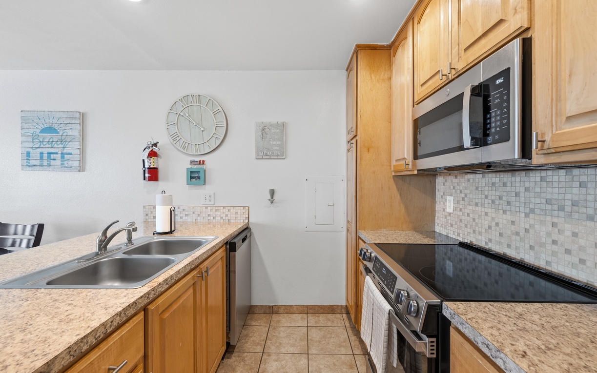 Your bright, fully-equipped kitchen makes meal prep a breeze with warm wood cabinetry, sleek granite counters, stainless steel appliances, and thoughtful coastal touches throughout.