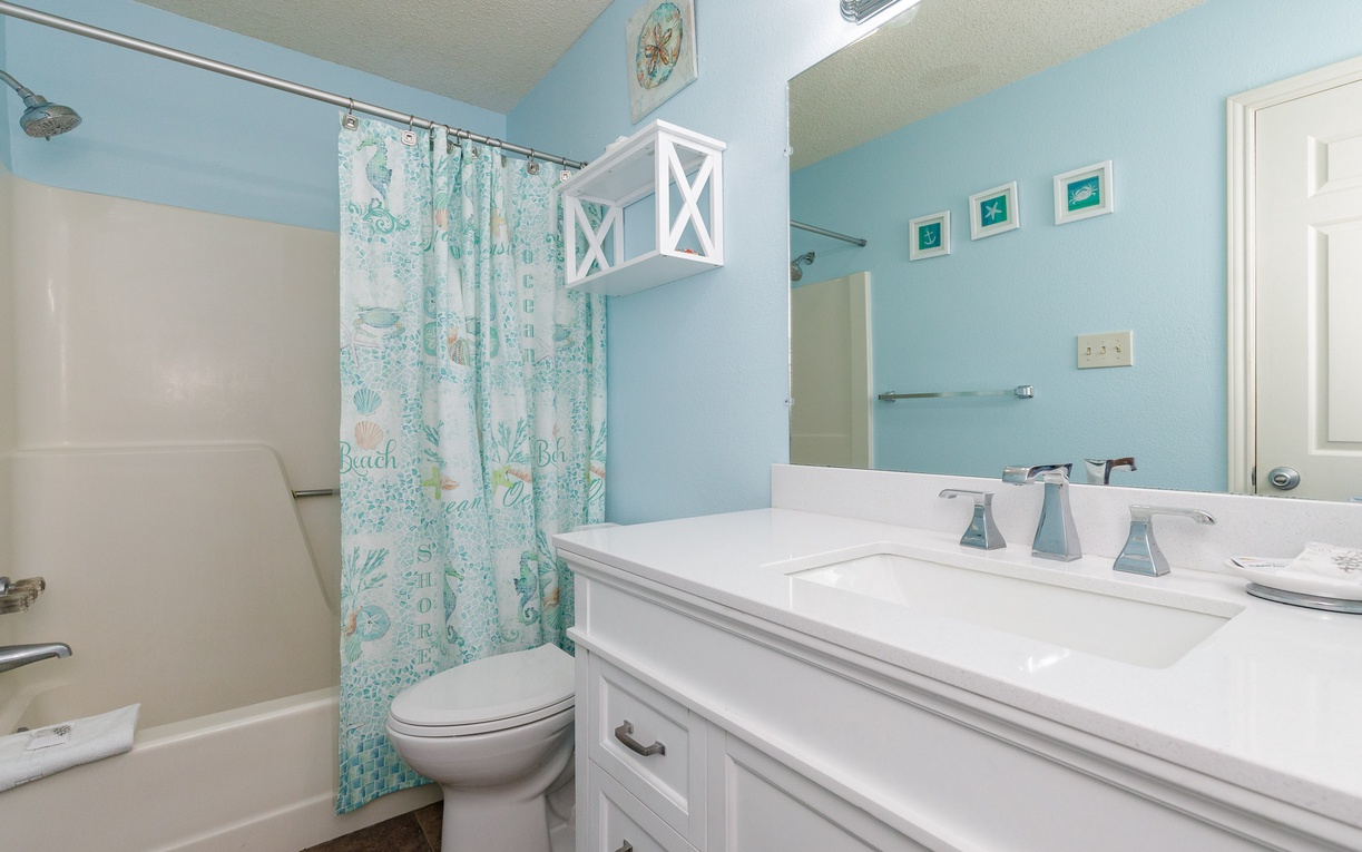 Step into your coastal-inspired bathroom where soothing seafoam walls and ocean-themed touches create your personal seaside retreat.