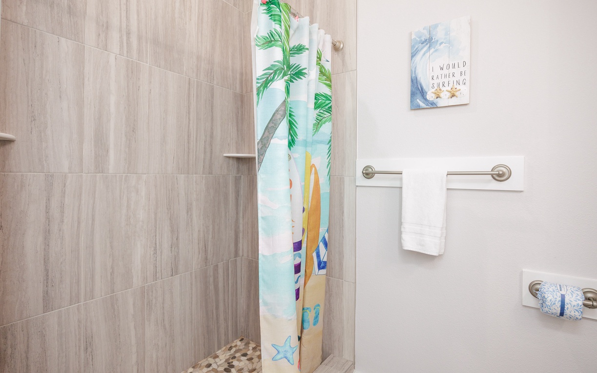 Your coastal-themed bathroom features a spacious walk-in shower with tropical beach curtain, perfect for refreshing after sunny beach days.