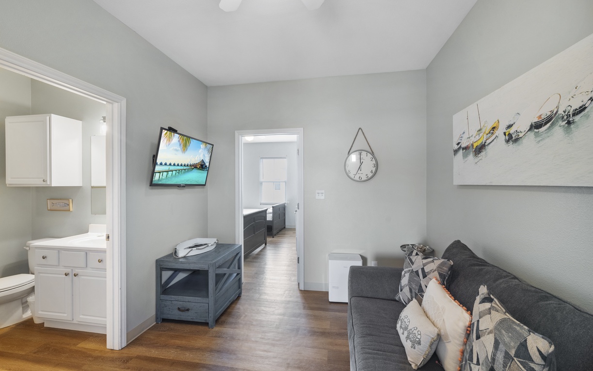 Relax in your stylish living space with coastal décor, modern furnishings, and a flat-screen TV for your entertainment.