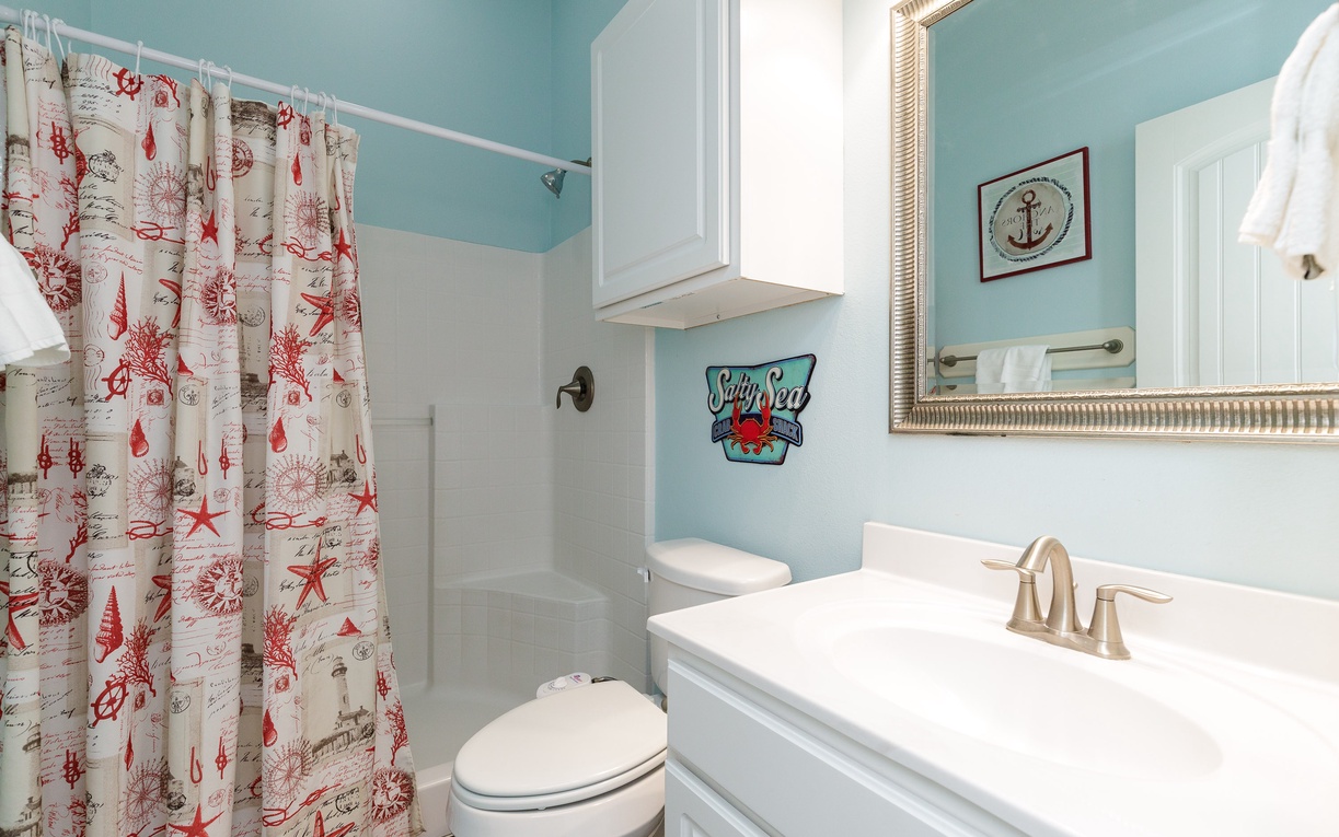 Refresh in your charming nautical bathroom with coastal touches and cheerful maritime decor throughout.
