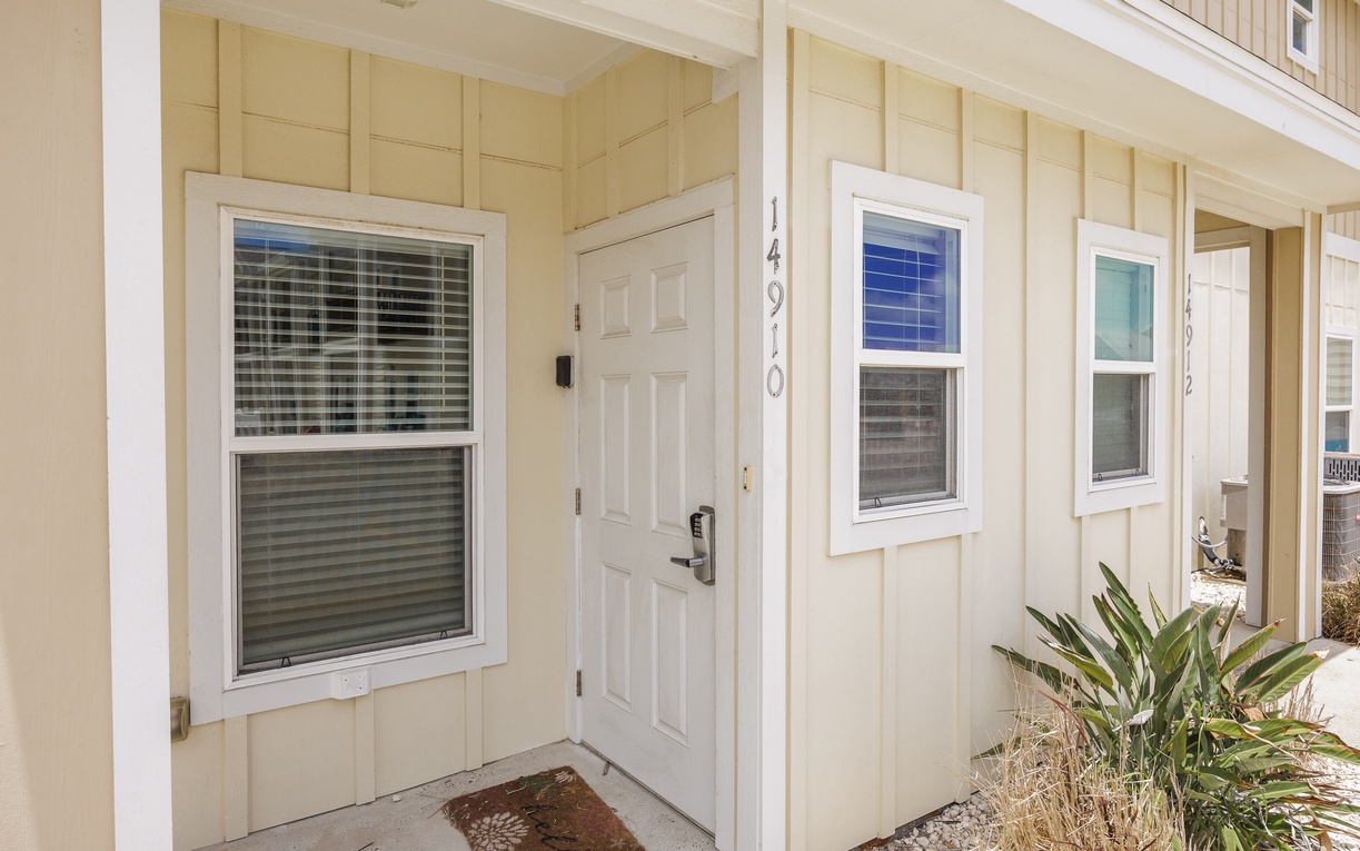 The welcoming entrance to your coastal retreat, featuring clean lines and modern comfort in a peaceful residential setting.