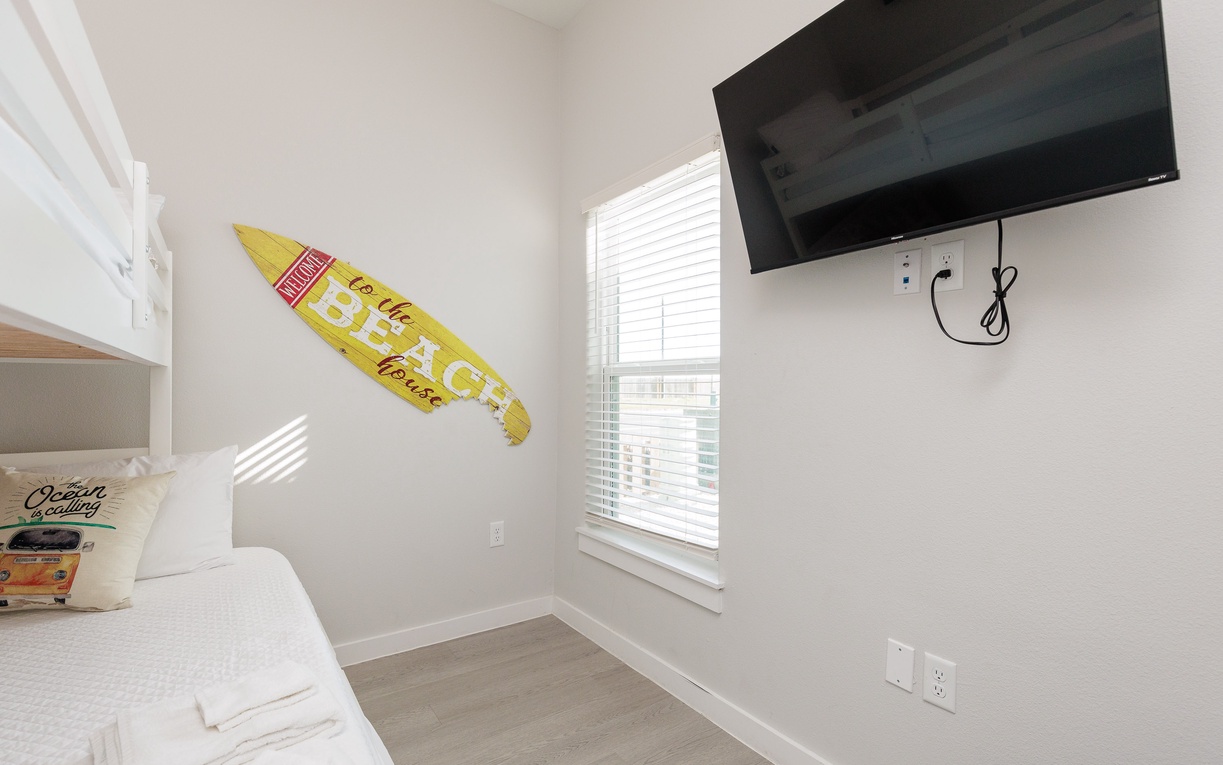 Relax in your bright bunk room with beach vibes and wall-mounted TV for your favorite shows.