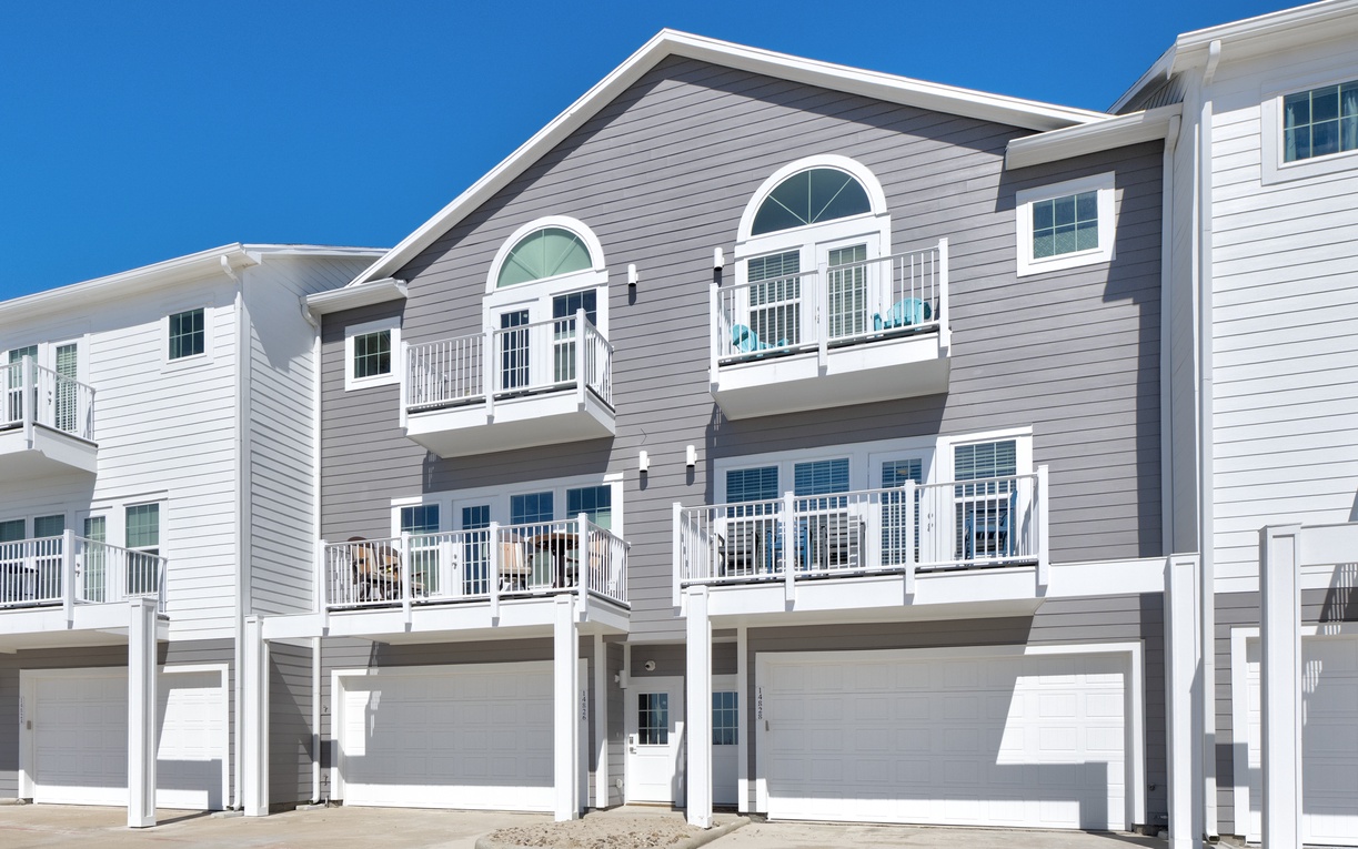 Modern coastal townhouse featuring spacious balconies and elegant architectural design in a pristine waterfront community.