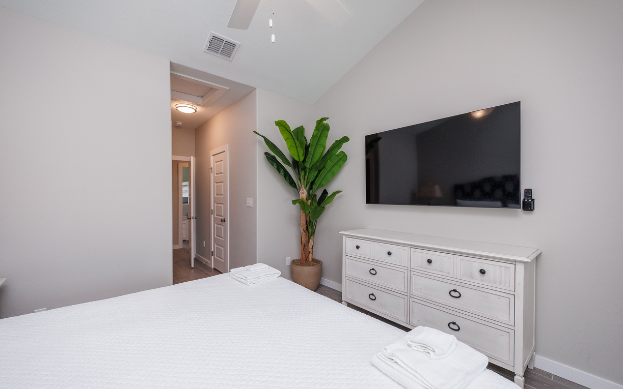 Your serene bedroom features vaulted ceilings, a wall-mounted TV, and fresh linens for ultimate relaxation after your adventures.