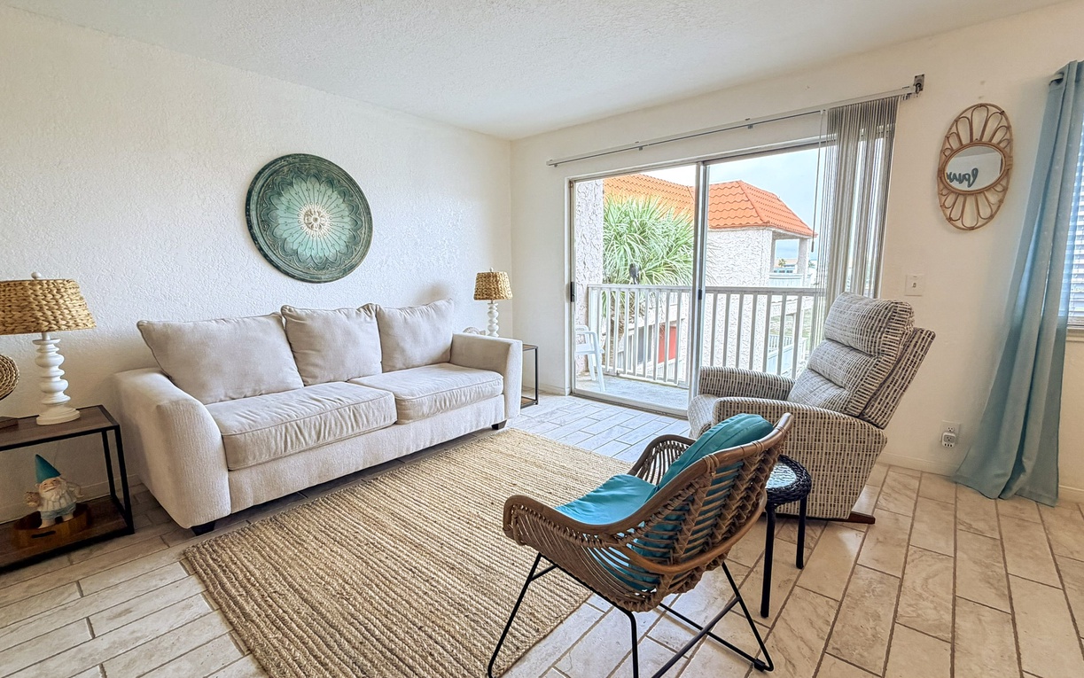 Sink into comfort in your bright living room with coastal vibes, plush seating, and peaceful views.