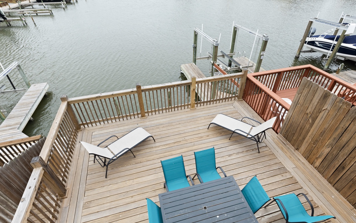 Your private waterfront deck awaits with comfortable lounge chairs and direct lake access for swimming and boating adventures. Enjoy the use of the boat slip, but no boat lift available.