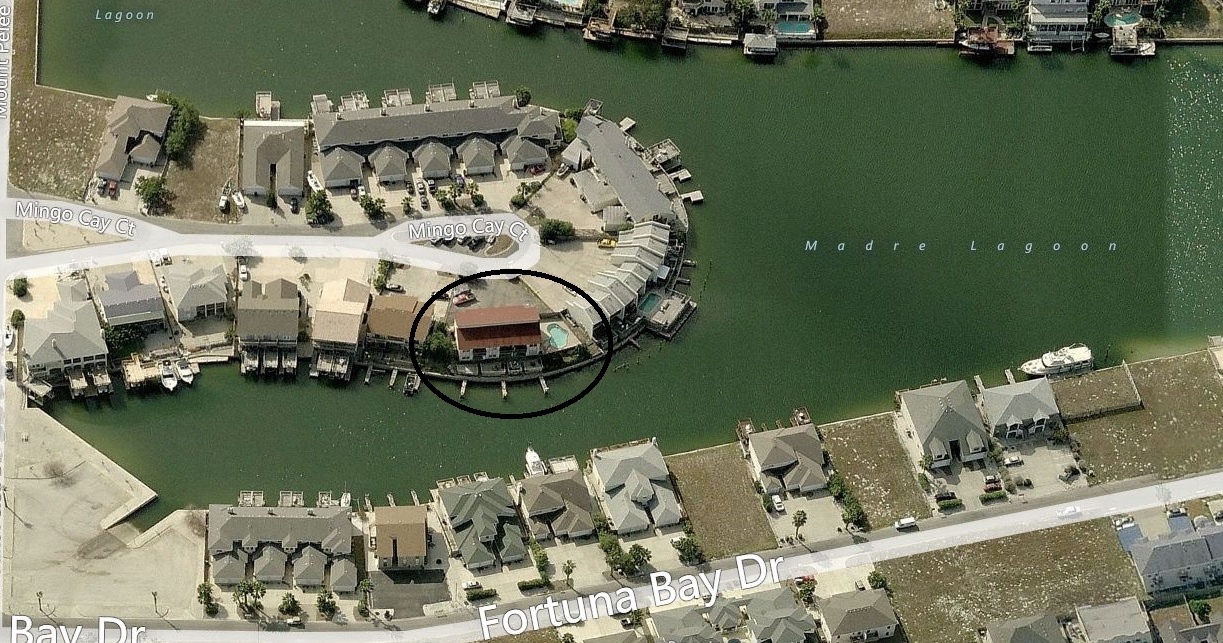 Aerial view of waterfront property location on Madre Lagoon with private dock access and marina surroundings.