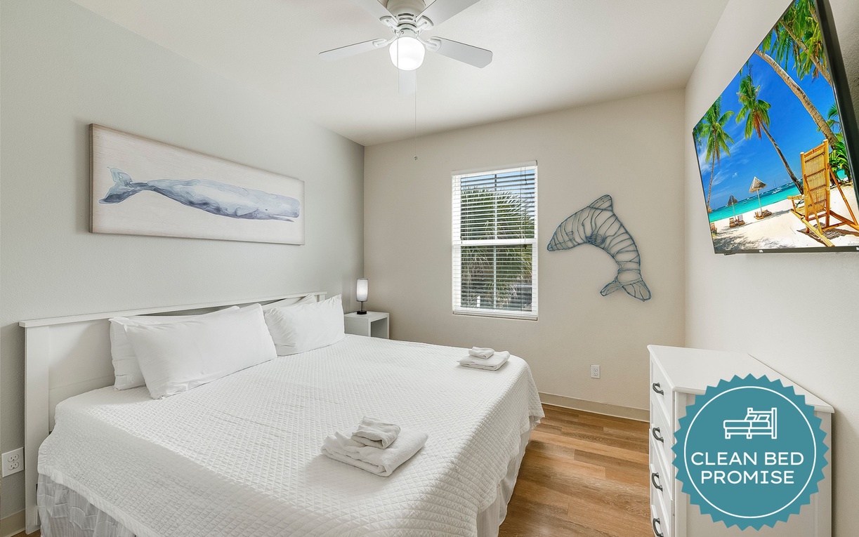 Unwind in your peaceful coastal retreat with ocean-themed art, ceiling fan comfort, and entertainment.