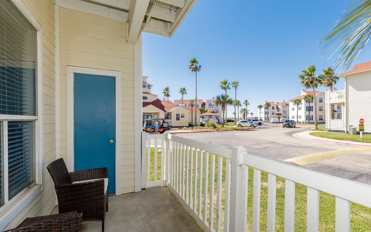 Bright beachside community with colorful doors and swaying palms creates a cheerful coastal retreat atmosphere.