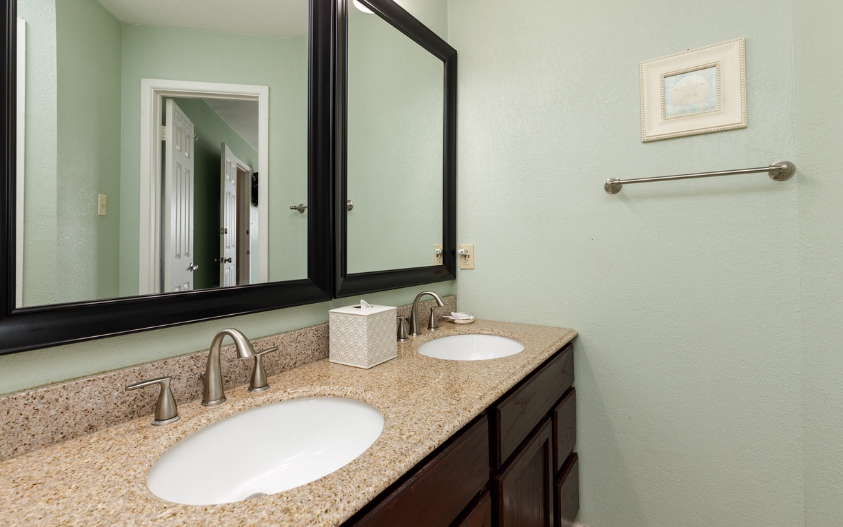 Your spacious bathroom features dual vanities with granite countertops, providing plenty of room for your morning routine.