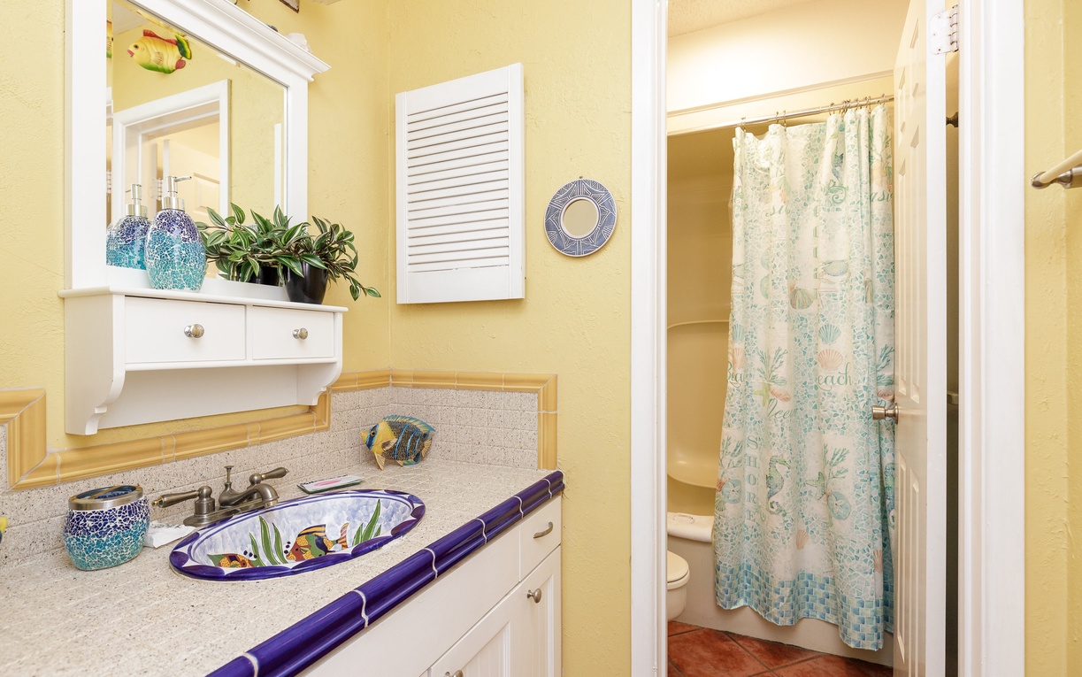 Bright, cheerful bathroom with coastal touches and thoughtful amenities to make your stay comfortable and refreshing.