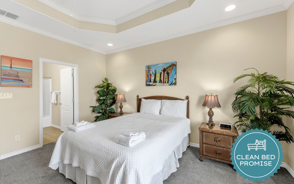 Rest peacefully in your elegant bedroom featuring fresh linens, warm lighting, and tropical touches that create a serene retreat.