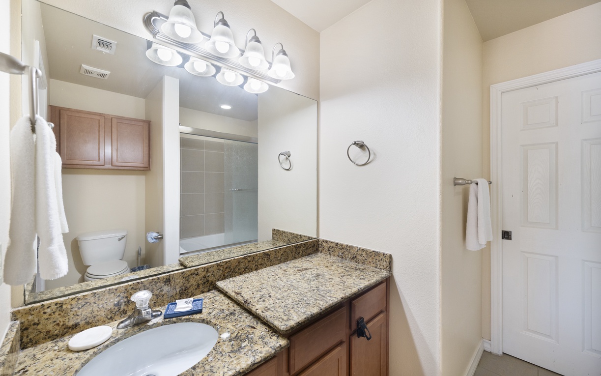 Your private bathroom offers granite countertops, a spacious vanity, and a refreshing shower ready for your arrival.