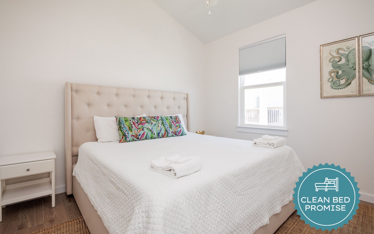 Sink into crisp white linens and let tropical accents transport you to paradise in this serene bedroom retreat.