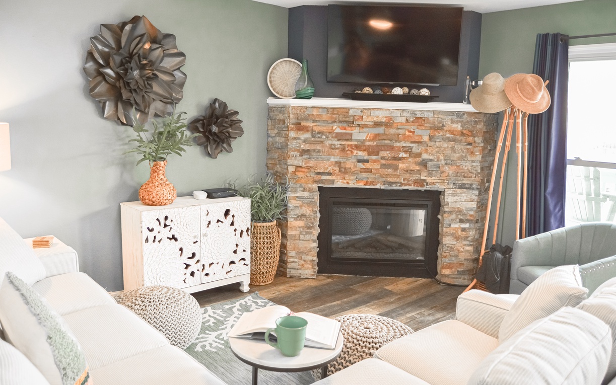 Unwind in your stylish living room featuring a cozy brick fireplace, plush seating, and warm décor that creates the perfect atmosphere for relaxation.