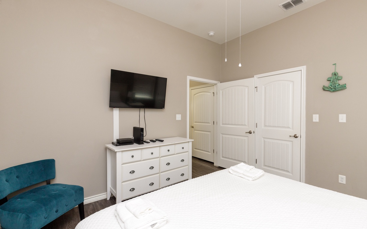 Relax in your peaceful bedroom with plush bedding, modern amenities, and charming coastal touches that make you feel right at home.