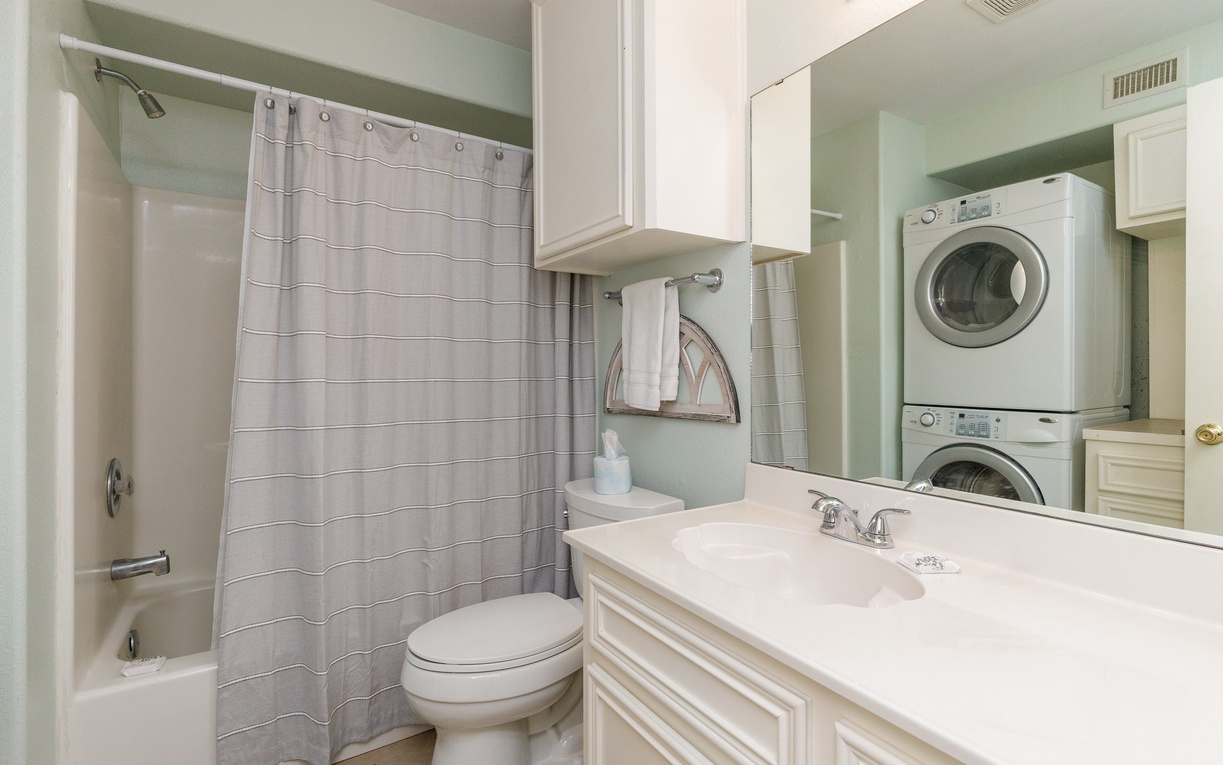 Your private bathroom features a relaxing tub-shower combo, vanity with storage, and convenient in-unit washer and dryer for extended stays.