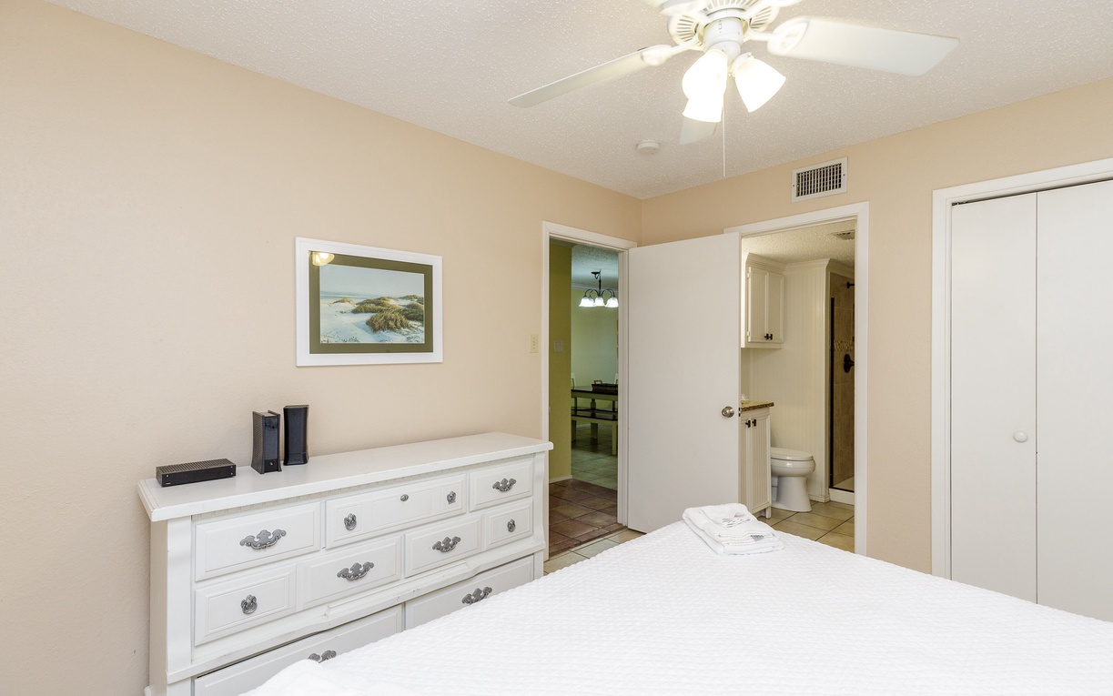 Your cozy bedroom features a comfortable bed, ample dresser storage, and convenient en-suite bathroom access for ultimate relaxation.