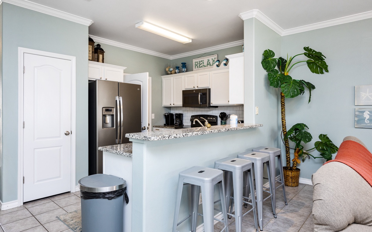Relax in your open kitchen with granite counters, stainless appliances, and breakfast bar seating—perfect for morning coffee or casual meals.