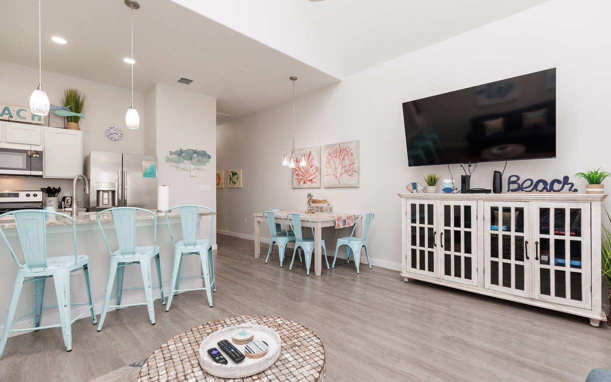 Relax in your bright, beach-themed living space with modern kitchen, cozy dining nook, and coastal décor throughout.