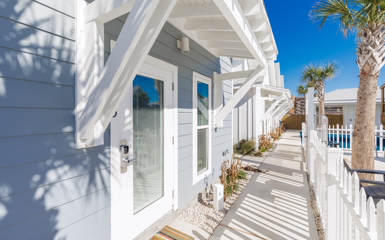 Coastal charm awaits at this bright beach house with palm trees and ocean breezes just steps from your door.