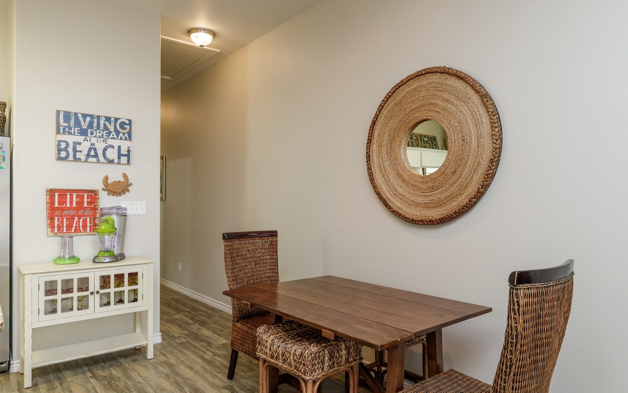 Your cozy dining nook features warm beach-themed decor and comfortable wicker seating for memorable meals together.