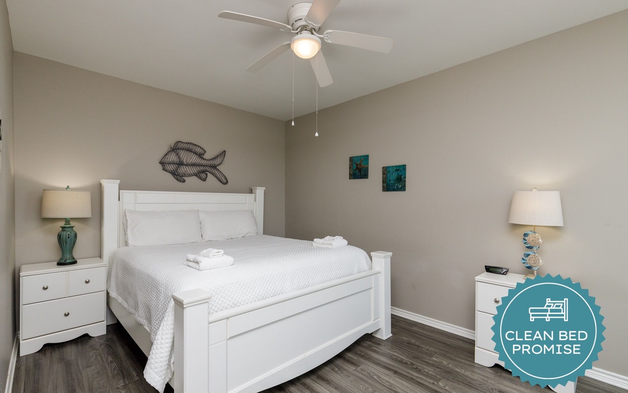 Your coastal retreat awaits with a comfortable queen bed, crisp linens, and soothing ocean-themed touches that promise restful nights.