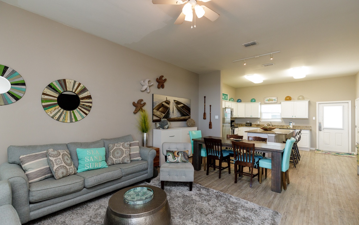 Step into your bright, open living space where coastal touches and modern comfort blend perfectly for relaxing evenings together.
