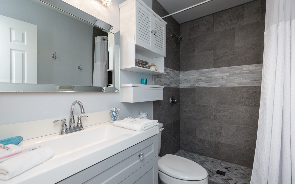 Refresh in your second floor guest bathroom featuring a sleek shower, pristine vanity, and stylish tile work perfect for unwinding.