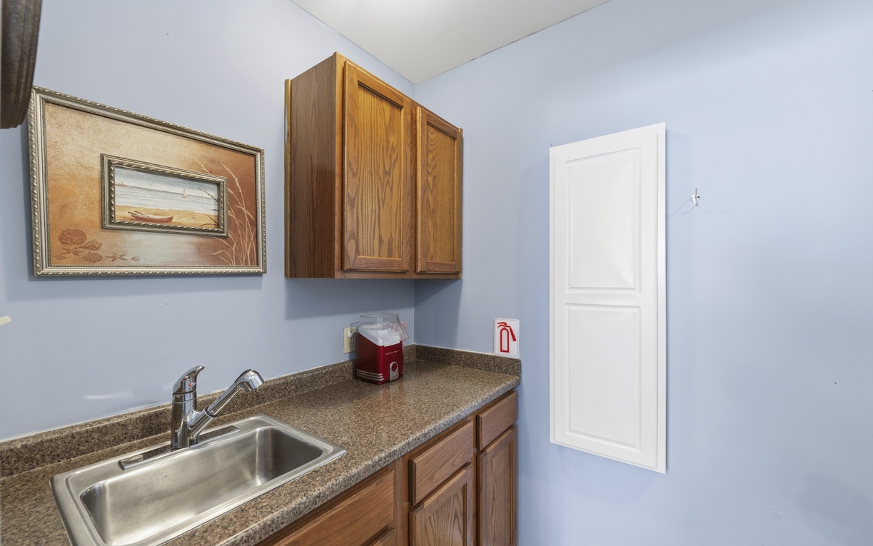 Your private kitchenette features warm wood cabinetry, a stainless steel sink, and granite countertops—perfect for preparing quick snacks or morning coffee at your leisure.