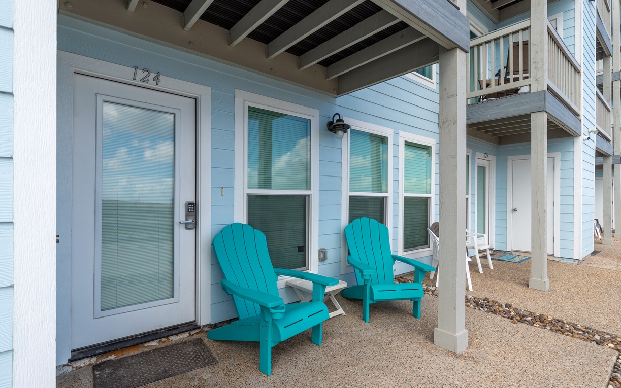 Relax in your turquoise Adirondack chairs on the covered porch, where coastal breezes and peaceful moments await you.