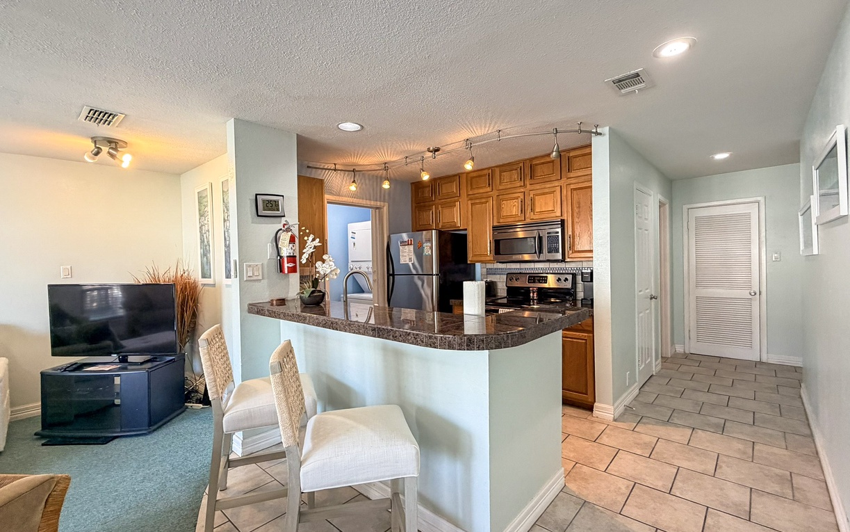 Your open-concept living flows seamlessly into a fully equipped kitchen with granite counters, perfect for cooking and entertaining together.