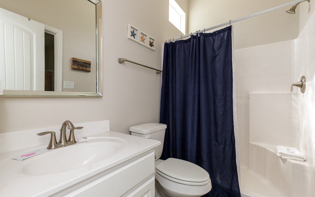 Refresh in your private bathroom featuring a spacious walk-in shower, elegant vanity, and thoughtful coastal touches that make getting ready feel like pure luxury.