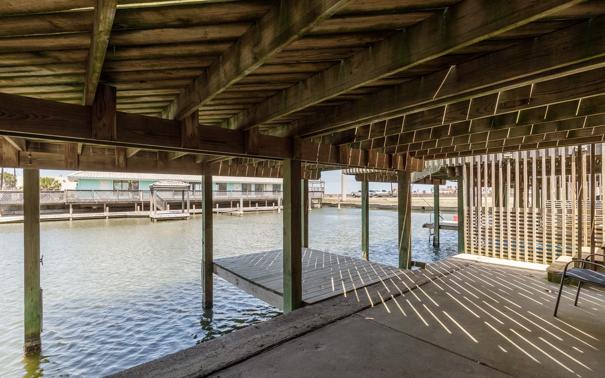 Your private boat dock awaits with covered slip and waterfront access, perfect for launching your next adventure on the water.