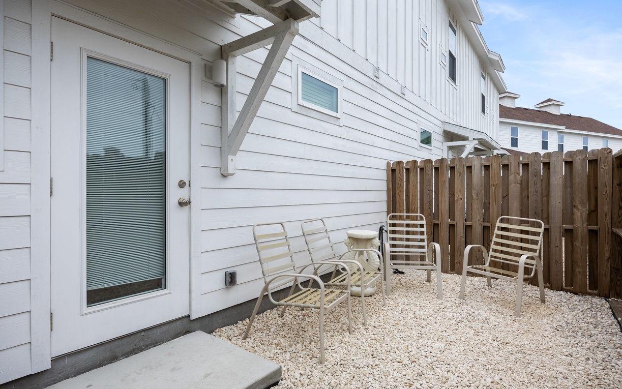 Your private patio offers a peaceful retreat with comfortable seating and gravel landscaping, perfect for morning coffee or evening relaxation.
