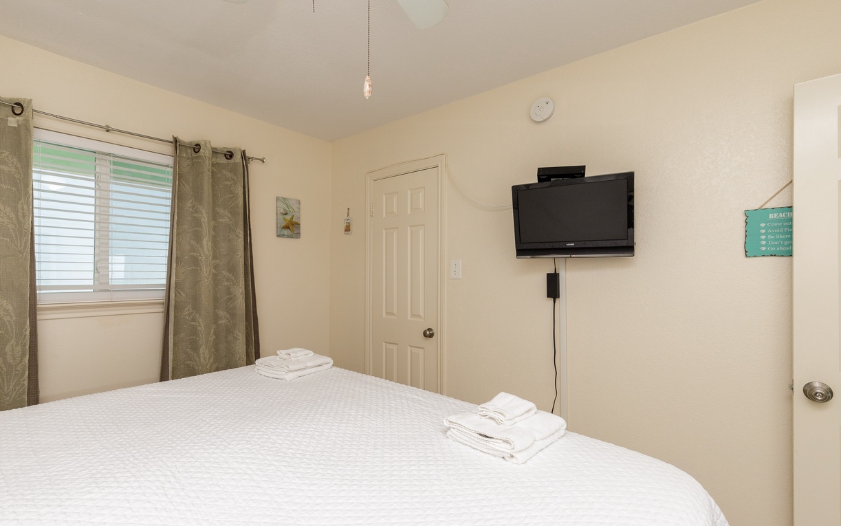 Relax in your peaceful bedroom with crisp linens and enjoy unwinding with your favorite shows on the wall-mounted TV.