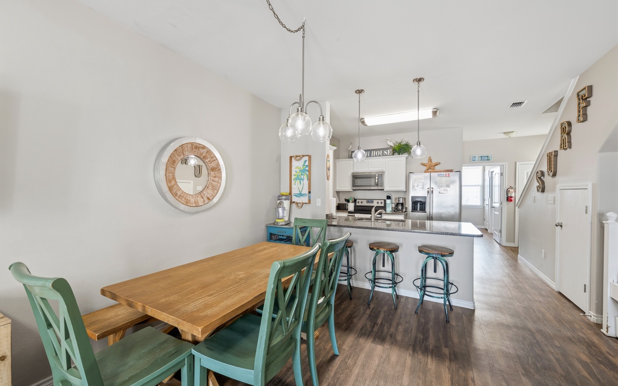 Gather around the inviting dining table or pull up a seat at the kitchen island—your home base for meals, morning coffee, and vacation planning together.
