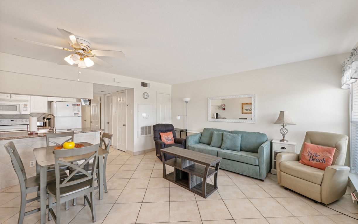 Your bright, airy living space features comfortable seating and an open kitchen, perfect for relaxing after beach days.