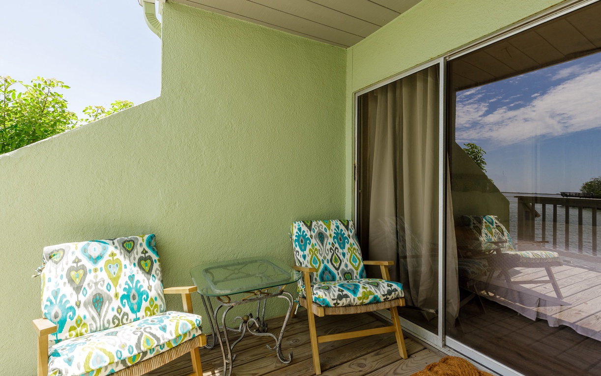 Step onto your private balcony where vibrant patterned chairs await your morning coffee or evening unwind beneath the peaceful sky.