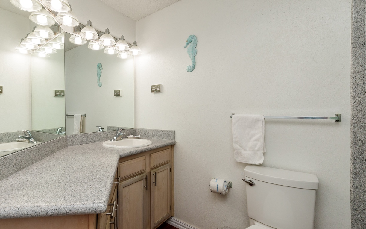 Freshen up in your private bathroom with granite countertops, excellent lighting, and coastal seahorse accents that bring seaside charm to your daily routine.