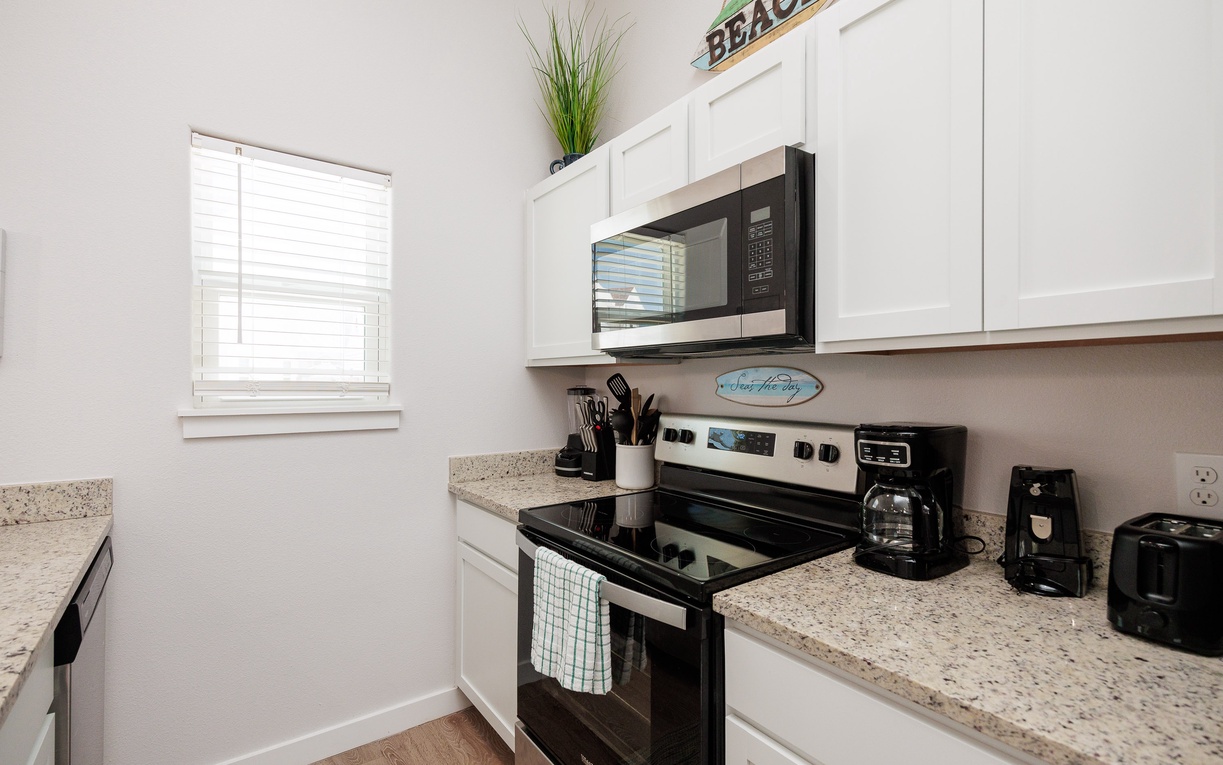 Your fully equipped kitchen invites you to create culinary memories with granite counters, modern appliances, and coastal charm.